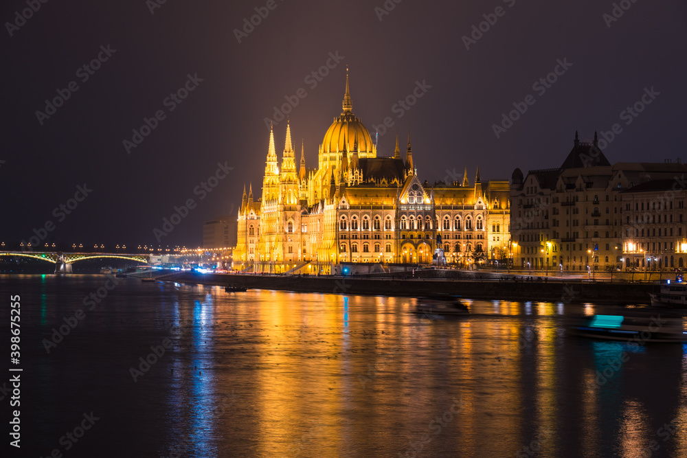 Side view of Hungarian Parliament illuminated at night in Budapest