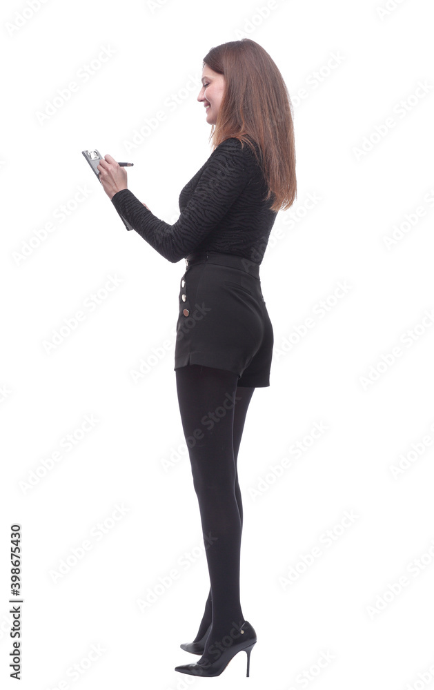 side view. young woman writing something to the clipboard. side view. young woman writing something to the clipboard.