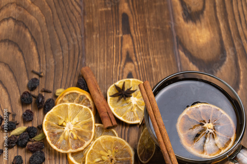 mulled wine with spices on a wooden background