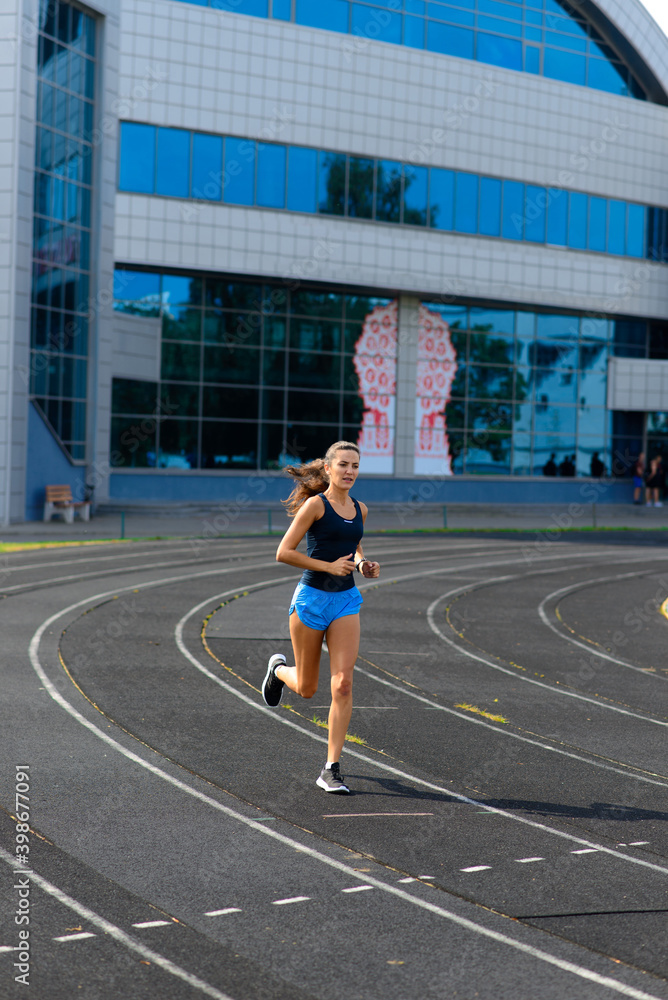 Fototapeta premium Athlete runner running on athletic track training her cardio.