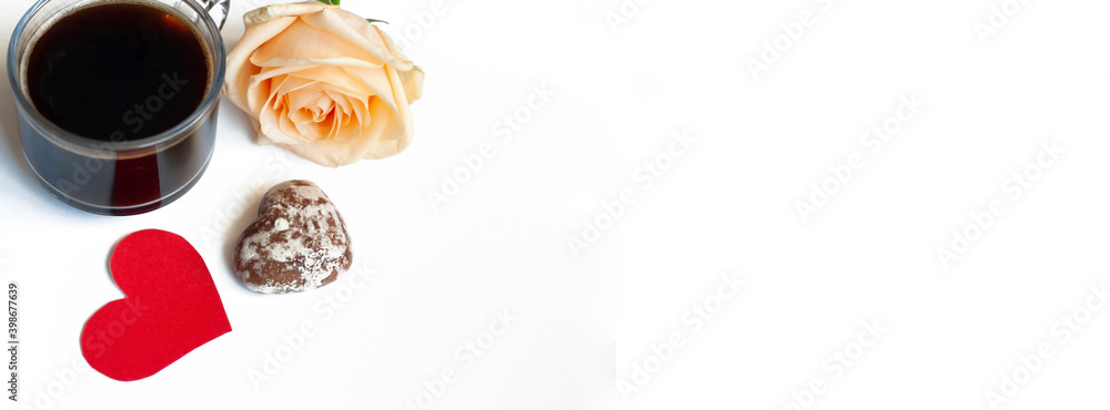 Banner coffee, chocolate cakes in the shape of hearts and a yellow rose on a white background, copy space Banner coffee, chocolate cakes in the shape of hearts and a yellow rose on a white background, copy space