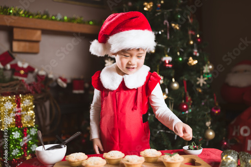 young girl preparing mince pie for celebrating  Christmas party © M-image