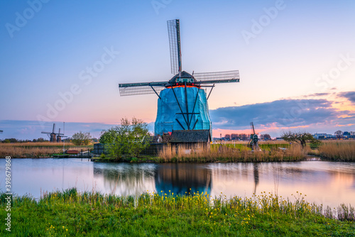Traditional Dutch windmill at sunset in Kinderdijk. Netherlands 