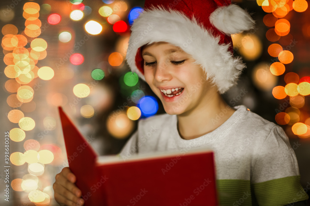 Boy, reading a book in front of a Christmas tree. Boy, reading a book in front of a Christmas tree.