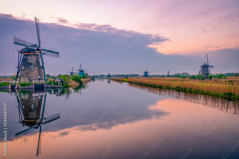 Traditional dutch scenery with windmills at sunset. Netherlands countryside Traditional dutch scenery with windmills at sunset. Netherlands countryside