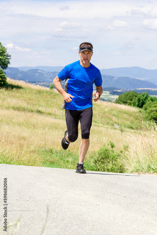 Runner athlete running on road at mountains background