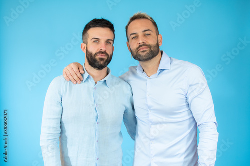 Young gay couple of two men wearing casual clothes hugging oneself happy and positive, smiling confident. self love and self care