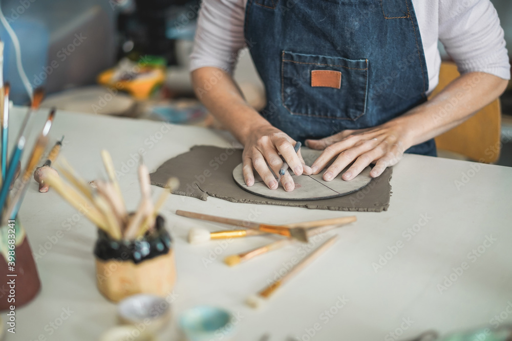 Fototapeta premium Hands view of woman making ceramics objects inside creative pottery studio - Art and workshop concept