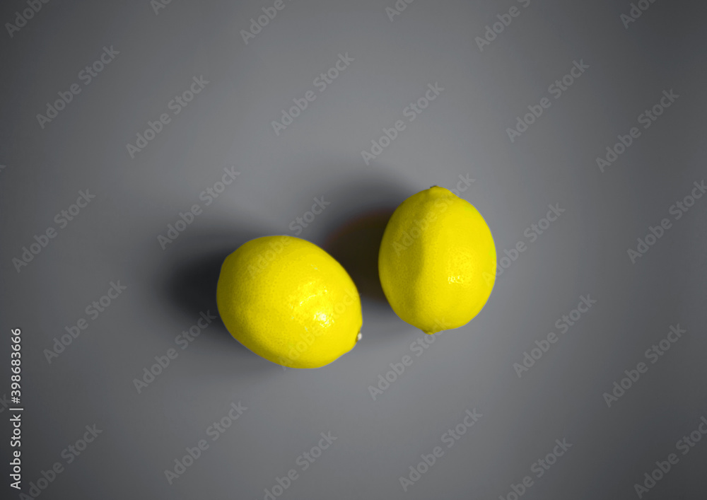 color concept of 2021. illuminating lemons on a ultimate gray background color concept of 2021. illuminating lemons on a ultimate gray background