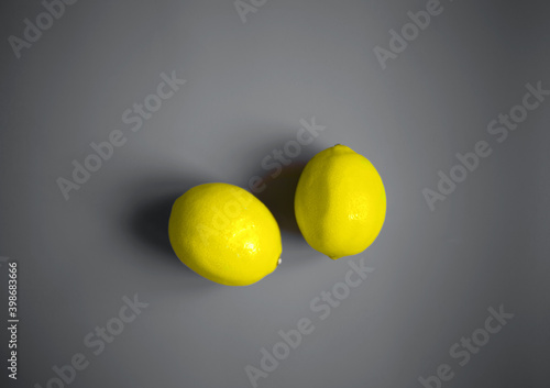 color concept of 2021. illuminating lemons on a ultimate gray background