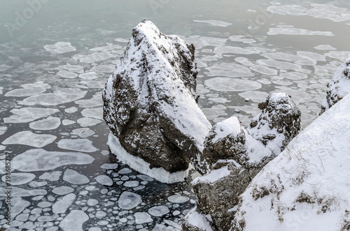 Rocks. Icicles. Ice floes. The frozen sea. Rocks. The ice. Sakhalin island. photo