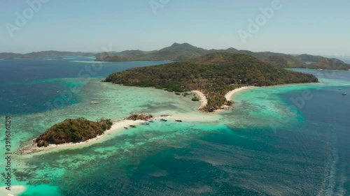 aerial seascape tropical islands and sand beach, turquoise water and coral reef. Bulog Dos, Philippines, Palawan. tourist boats on coast tropical island. photo