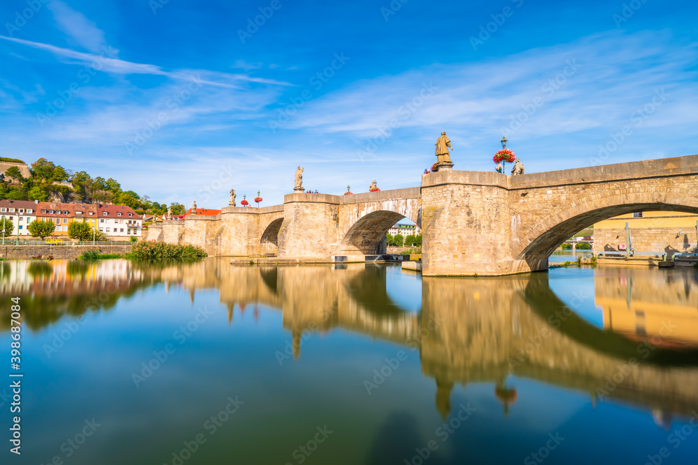 Beautiful view of old main bridge of Wurzburg with reflection in the river. Germany