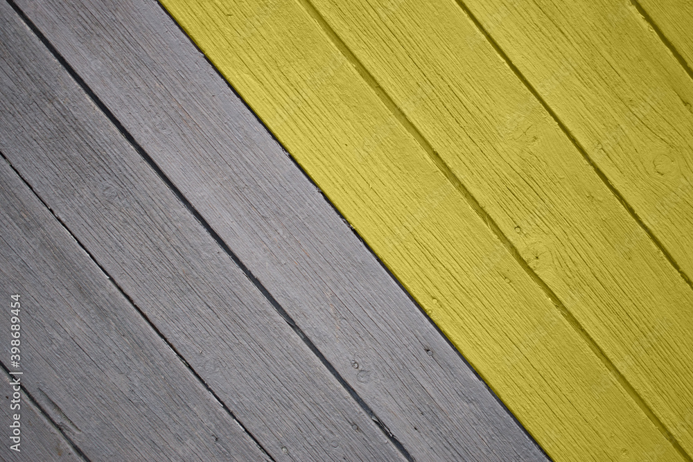 Background of many grey and yellow aged planks with minor natural defects set in diagonal. Demonstration of the main color trend of the year 2021. Background of many grey and yellow aged planks with minor natural defects set in diagonal. Demonstration of the main color trend of the year 2021.