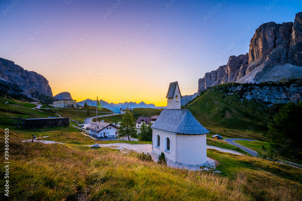 Sunrise view of San Maurizio chapel at Passo di val Gardena valley in Dolomites Alps. Italy