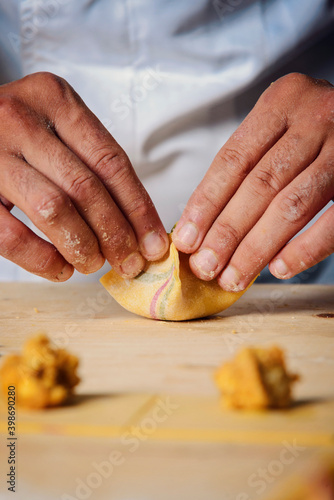 Chef hands creating colorful ravioli..Italian concept food.