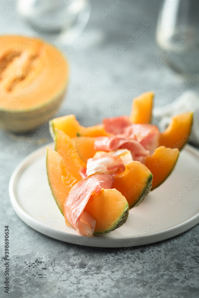 Delicious melon with jamon or smoked ham Delicious melon with jamon or smoked ham