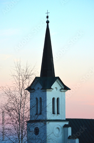 Lutheran church tower on sunset sky background. Colorful pink and blue sky. Architecture in High Tatras, Slovakia.