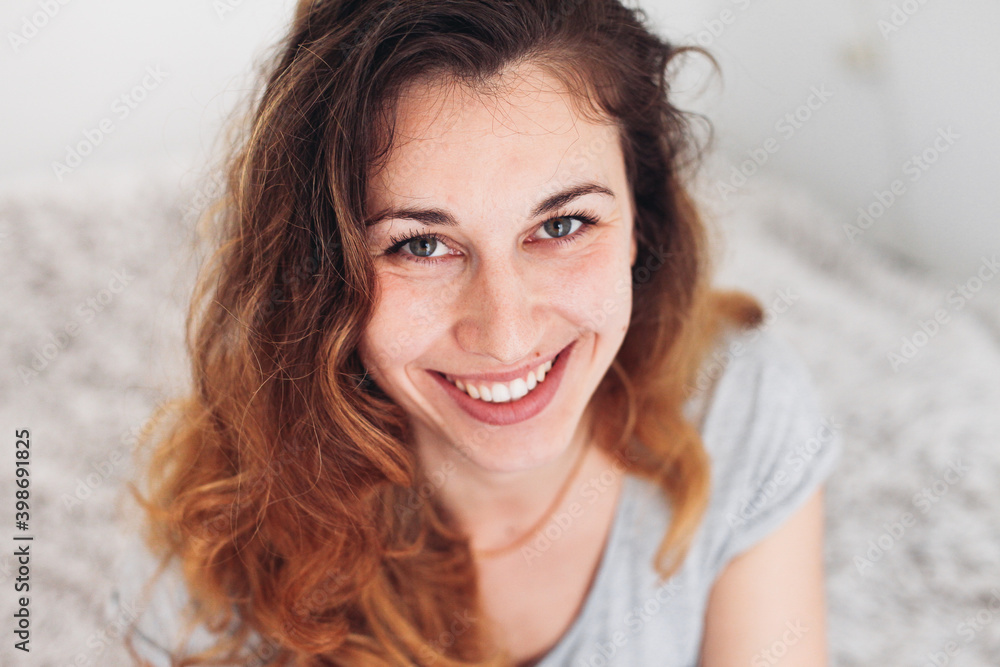 A young woman smiling and looking at the camera A young woman smiling and looking at the camera