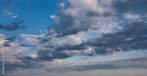 Blue summer sky with white cumulus clouds. Blue sky with clouds nature background.