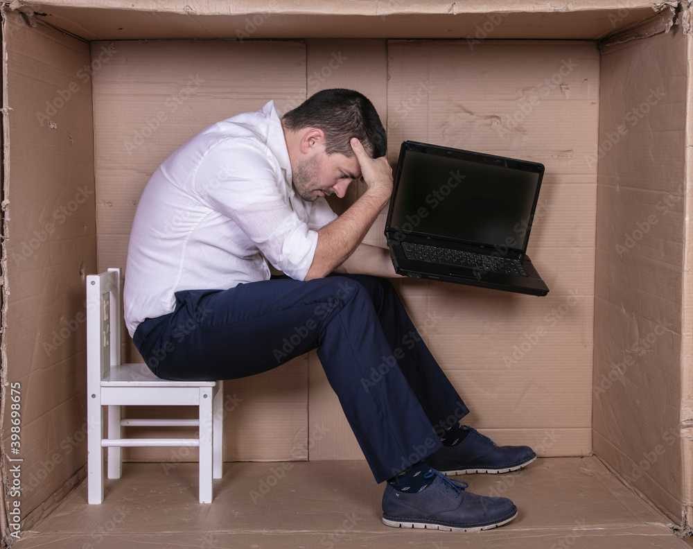 broken businessman in a cardboard office, stress and depression from overwork