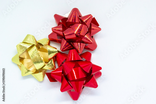 Gold and red gift wrap bows on a white background