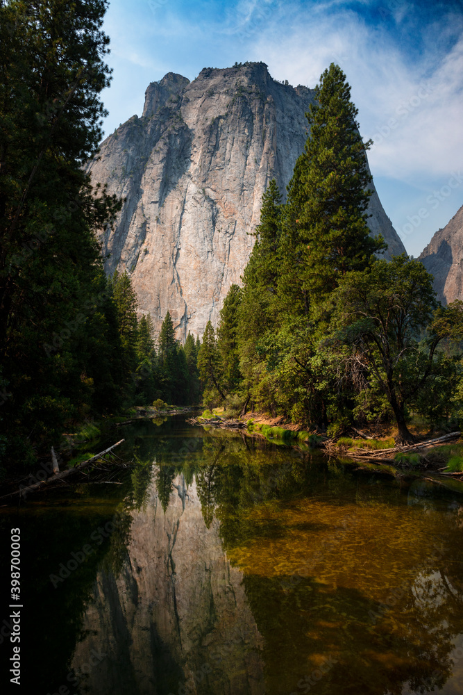 Scenic view of the merced river in the Yosemite valley, with the rocky mountains reflected on the water, in California, USA.