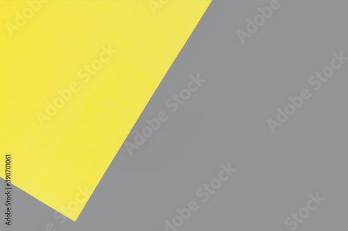 Colors 2021 - Gray and Yellow. Abstraction from multicolored paper backgrounds with contrasting shadows