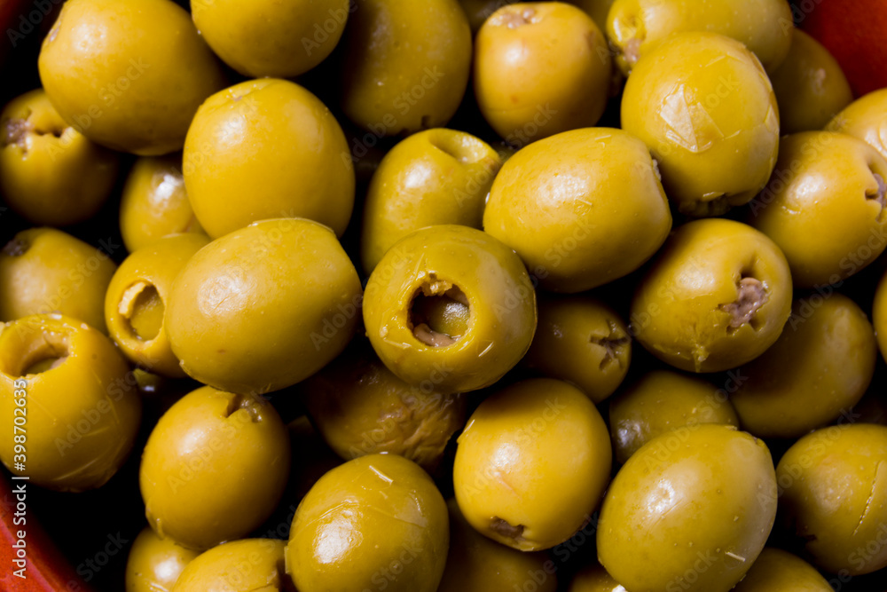 Detail of Olives stuffed with anchovies in a ceramic bowl and white background