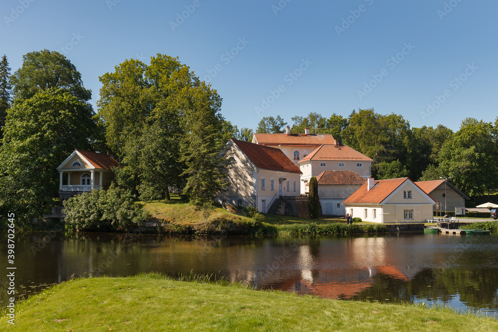 Obraz premium Vuhula is the manor in the north of Estonia. 18 century. Manor buldings by the pond.