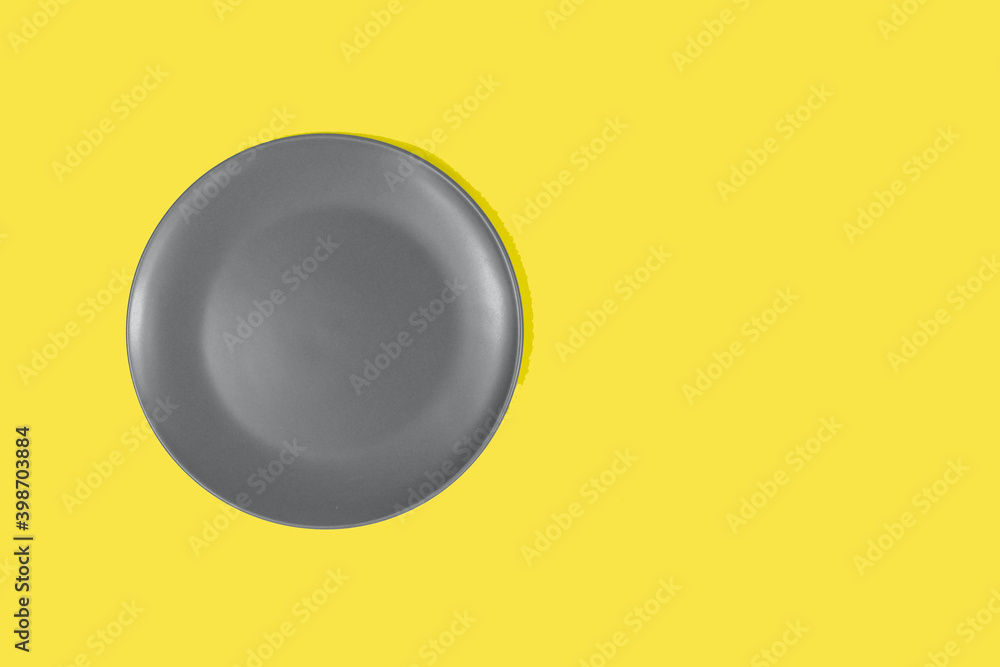 A gray teatka on a bright yellow background. Showcasing the trendy colors of 2021 - gray and yellow. Place for an inscription. A gray teatka on a bright yellow background. Showcasing the trendy colors of 2021 - gray and yellow. Place for an inscription.