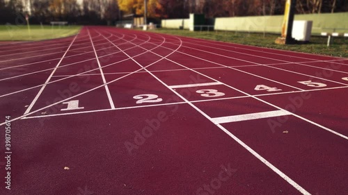 Aerial footage of running track in a sport stadium. first person view of a runner in a competition. Victory at the finishing line.