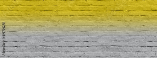 Grey banner old brick wall covered with yellow lime.