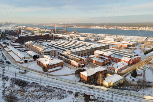Aerial view o factory with lots of buildings and railways in snowy Perm