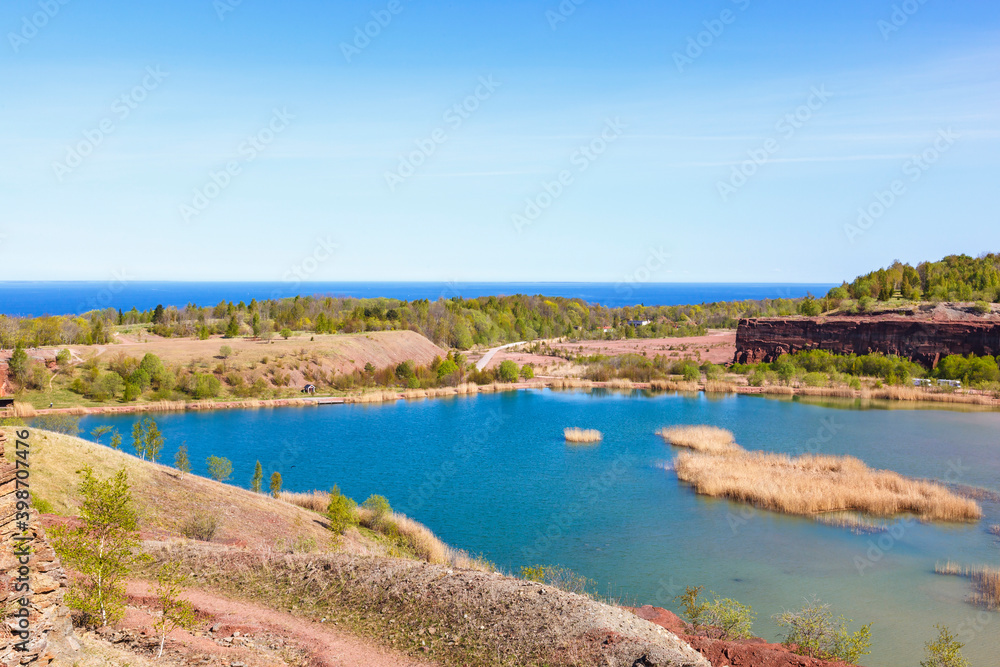 Old abandoned open pit with a lake and rock walls