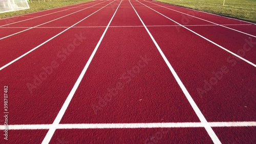 Aerial footage of running track in a sport stadium. first person view of a runner in a competition. Victory at the finishing line.