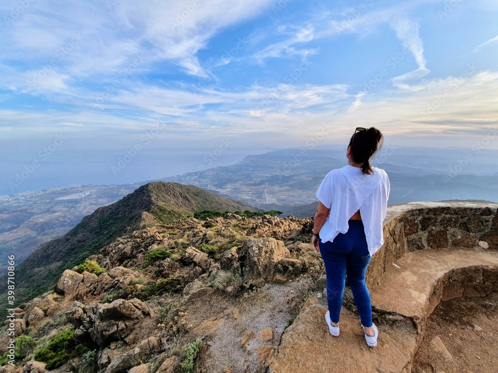 Fototapeta premium person on the top of a mountain