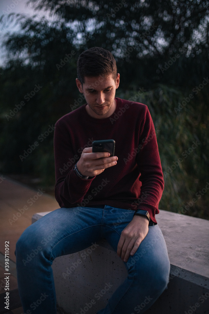 Attractive blond man using a mobile phone. Technology concept. Attractive blond man using a mobile phone. Technology concept.