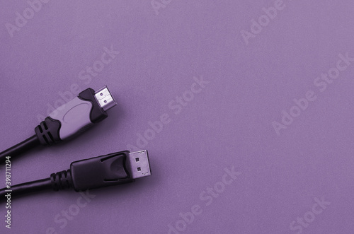 Audio video HDMI computer cable plug and 20-pin male DisplayPort gold plated connector for a flawless connection on purple backdrop photo