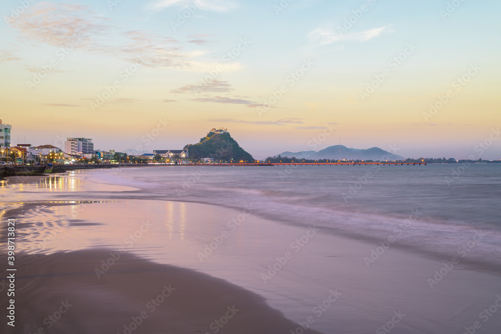 Obraz premium Beautiful city landscape from the viewpoint at Prachuap Khiri Khan Province, Thailand. Wat Khao Chong Krachok on top of mountain in sunset.