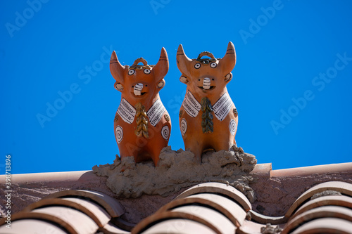 Peru typical traditional house protection on the roof. Two bulls named toritos photo