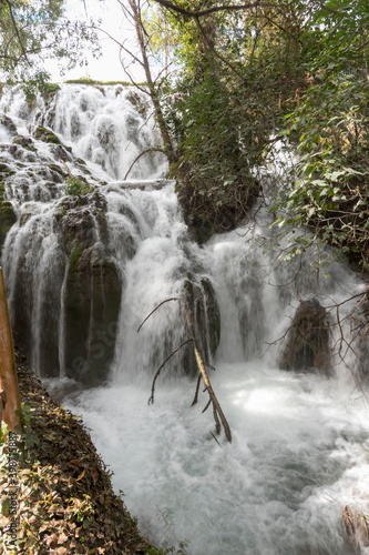 Beautiful view of the La Paradera waterfall surrounded by greens in Zaragoza, Spain photo