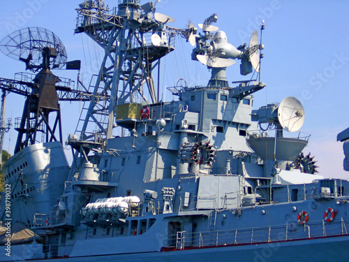 Missile cruiser (warship, battleship) battle ship closeup. Aircraft carrier russian military war battle cruiser ship (army boat) with missile launcher. Warship missile cruiser security navy in water