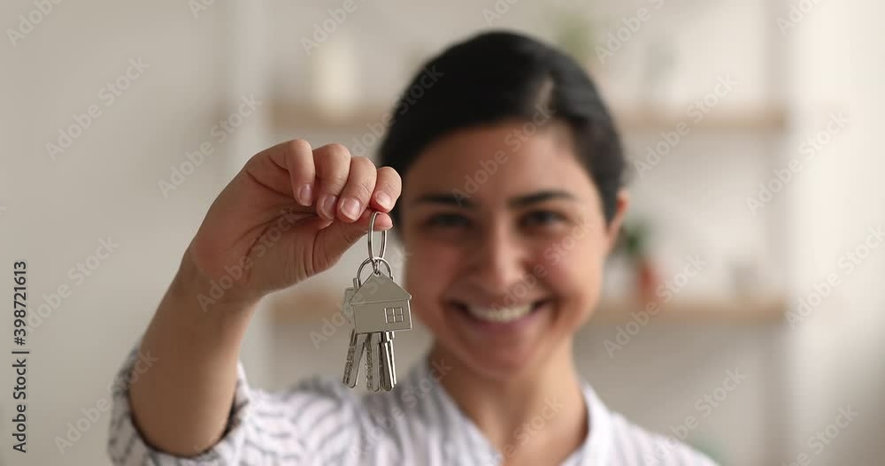 Close up view female hand holding keys from new house. Happy young ...