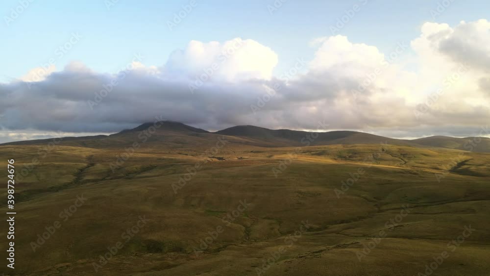 Vast Brecon beacons national park llyn y fan fach mountain range aerial slow right dolly across green valleys Vast Brecon beacons national park llyn y fan fach mountain range aerial slow right dolly across green valleys