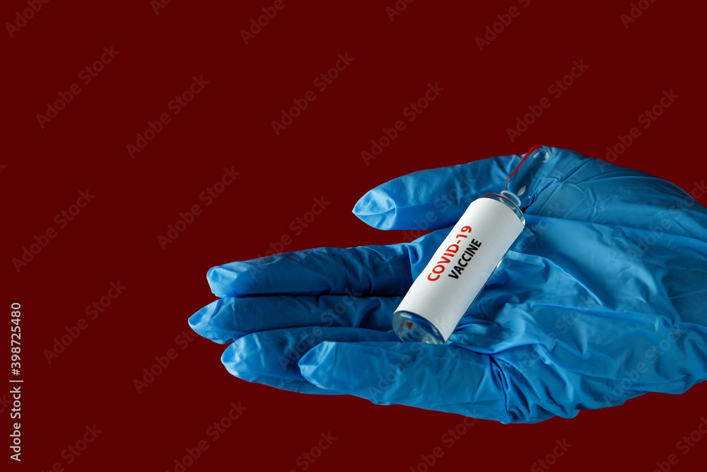 Female doctor holding syringe and COVID-19 vaccine isolated on red background. Healthcare And Medical concept. Female doctor holding syringe and COVID-19 vaccine isolated on red background. Healthcare And Medical concept.