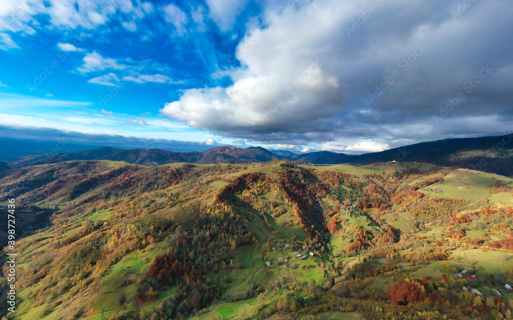 Fly over landscapes of green hills under a layer of white and fluffy clouds Fly over landscapes of green hills under a layer of white and fluffy clouds