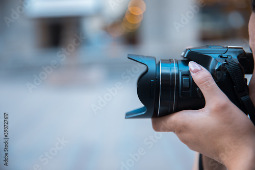 woman holding camera in street
