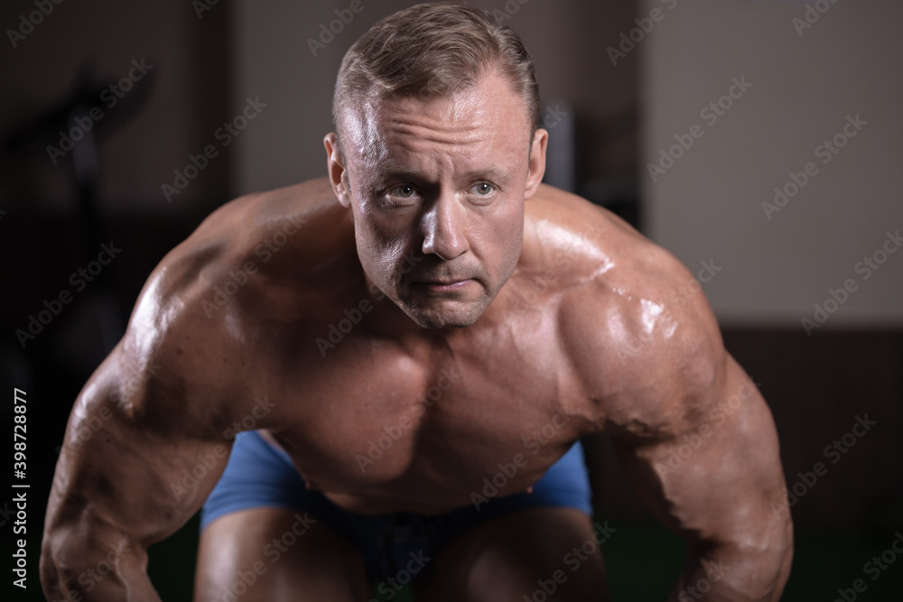 A male athlete works out on simulators and trains his muscles. Bodybuilding classes A male athlete works out on simulators and trains his muscles. Bodybuilding classes