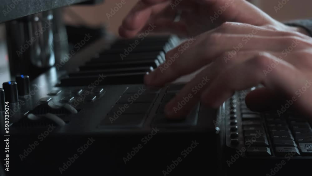 Male hands playing electronic keyboard, midi keys on the table. Male hands playing electronic keyboard, midi keys on the table.